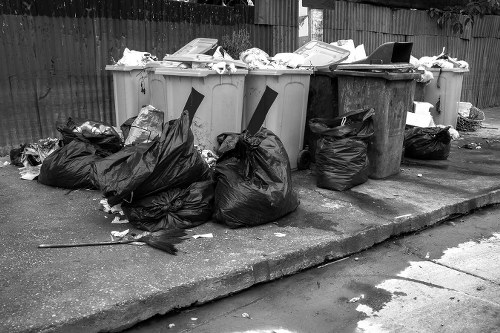 Demolition site with construction workers managing waste