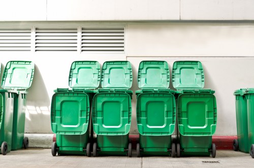 Builders using a skip on a construction site in Acton